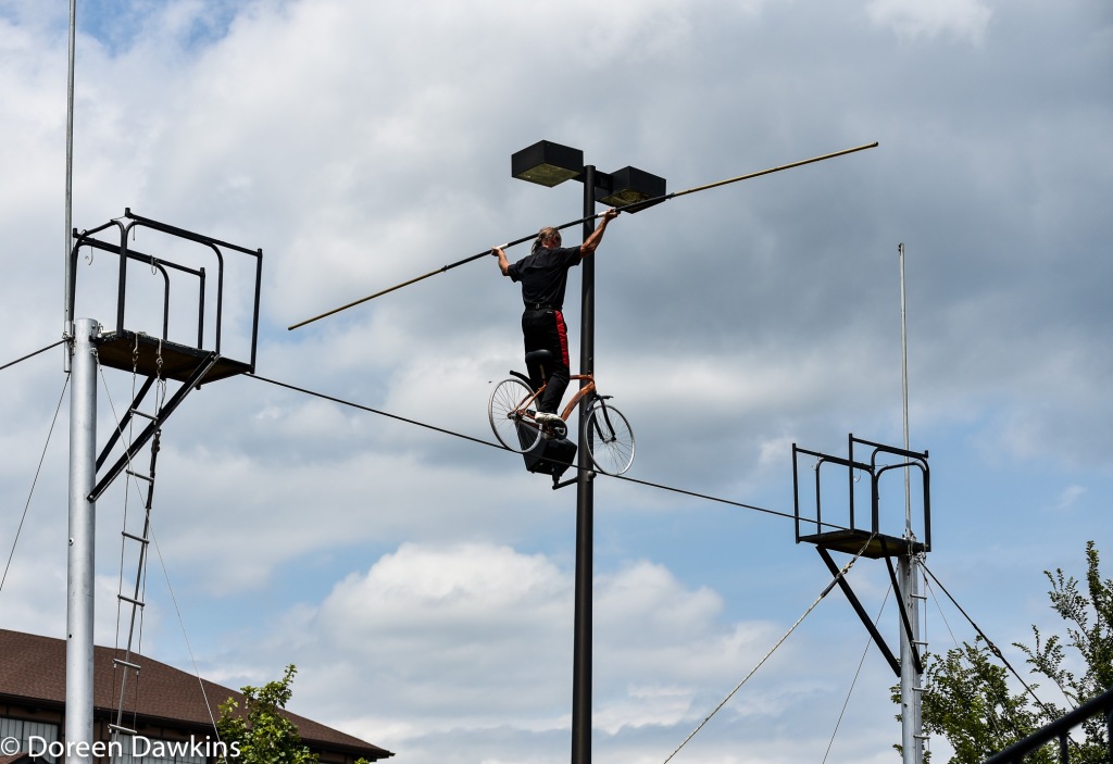 Jim Decker of the Human Cannonball Crusaders balancing on the bicycle on the high wire, Ohio State Fair 2019